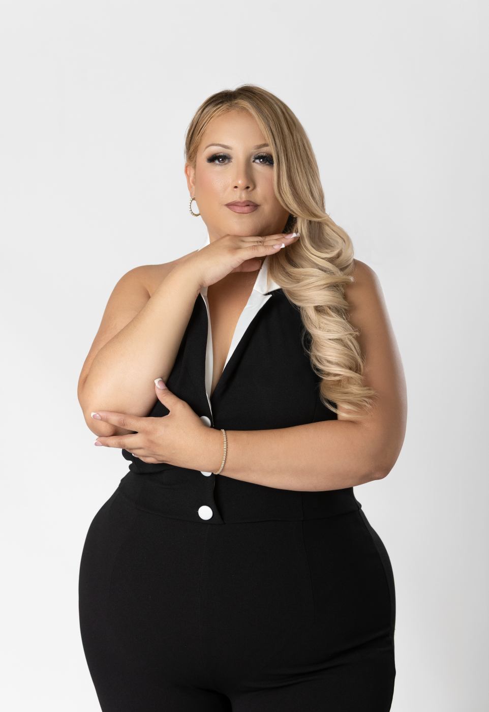 Professional studio portrait of a woman in a black suit